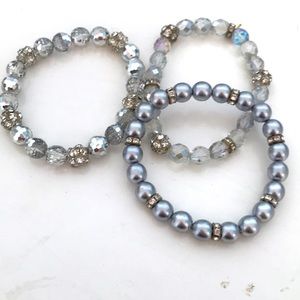 Stack of crystal beaded stretch bracelets.